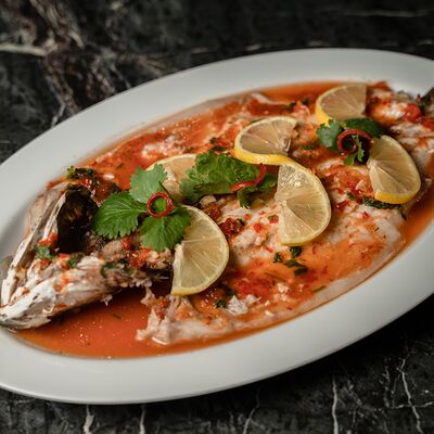 Сибас на пару с травами в Tsingtao по цене 2300 ₽