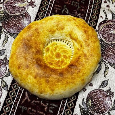 Лепешка узбекская (половина) в Каракилис по цене 39 ₽