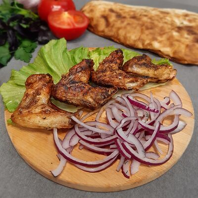 Куриные крылышки на мангале в Шашлычный дом по цене 490 ₽