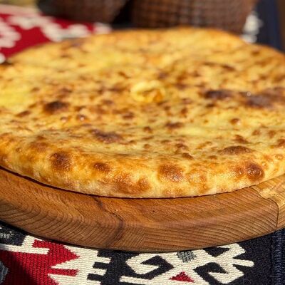Осетинский пирог с картофелем и сиром сулугунив Кинто по цене 1281 ₽