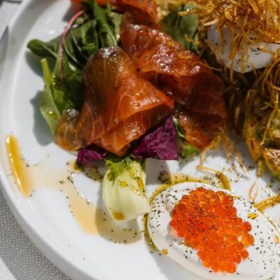 Драники со слабосоленым лососем, миксом салата, яйцом пашот, сметаной и красной икрой в Harvey & Monica по цене 850 ₽