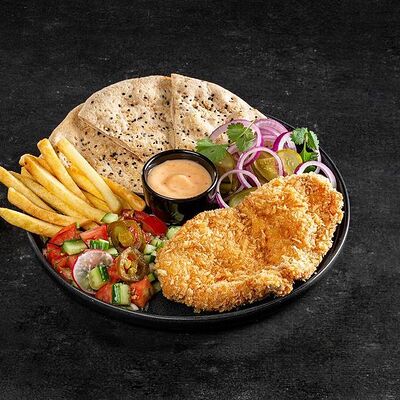 Шницель на тарелке в Bright Israeli Grill по цене 450 ₽