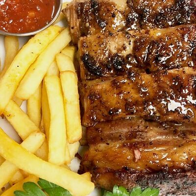 Фирменные свиные ребрышки в Первая реберная Кухня по цене 650 ₽