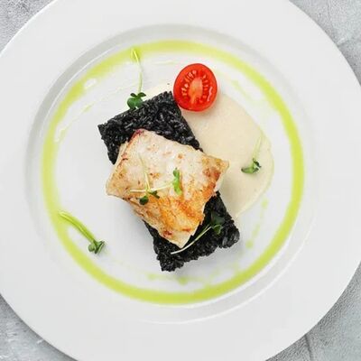 Угольная рыба с черным ризотто и соусом из белого вина в Four по цене 1450 ₽