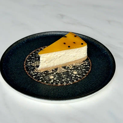 Цитрусовый чизкейк с желе апельсин-маракуйя в Prana по цене 450 ₽