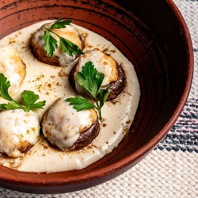 Фаршированные шампиньоны в сливочном соусе в Нино по цене 610 ₽