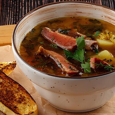 Суп из красной чечевицы с копчеными свиными ребрышками в У Ханумы по цене 430 ₽