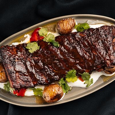 Томленые ребра в глазури из копченого лука с запеченным картофелем в Черная река по цене 970 ₽