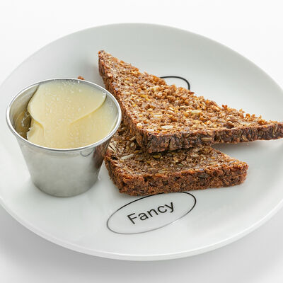 Злаковый хлеб с маслом в Nothing Fancy по цене 400 ₽