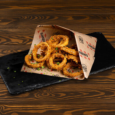Луковые кольца кейджин в TGI FRIDAYS по цене 245 ₽