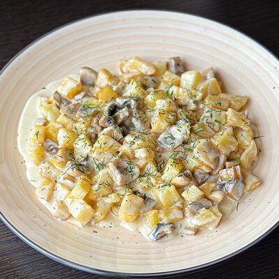 Картофель с грибами в сливочном соусе в Навруз по цене 350 ₽