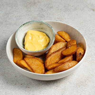 Картофельные дольки с сырным соусом в Бурка по цене 345 ₽