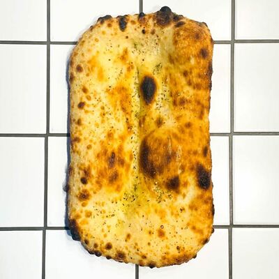 Хлеб с орегано в Padre pizzeria bar по цене 220 ₽