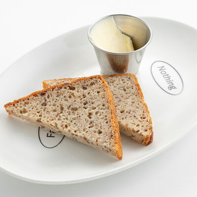 Безглютеновый хлеб с маслом в Nothing Fancy по цене 450 ₽