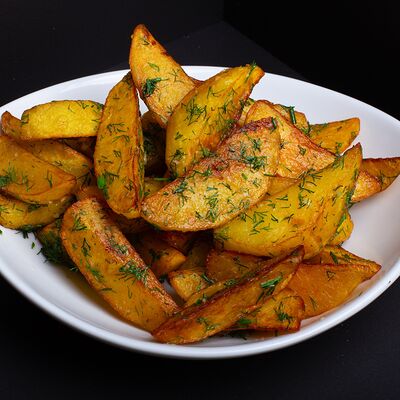 Картофель с чесночным соусом в Рябинушка по цене 195 ₽