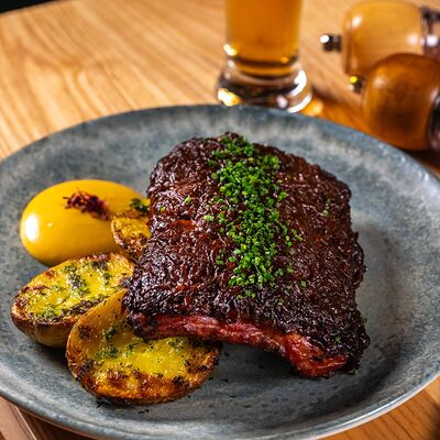 Свиные ребра сувид под соусом вишневый BBQ с запеченным картофелем в Just Residence по цене 1240 ₽