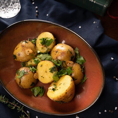 Картофель с зеленью и чесноком в Ирландский паб Тринити по цене 250 ₽