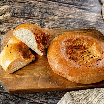 Лепешка тандырная по-узбекски в Ватруш пекарня-кондитерская по цене 70 ₽