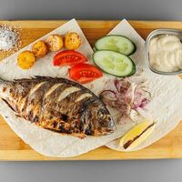 Дорадо на углях в Meat & Grill