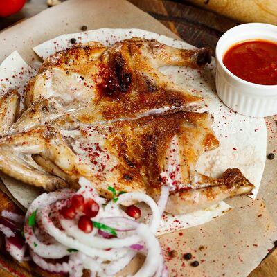 Цыплёнок в тандыре в Мангал & Гриль по цене 660 ₽