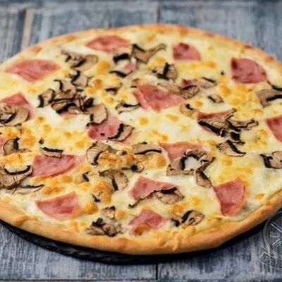 Пицца ветчина грибы в PANORAMA по цене 620 ₽