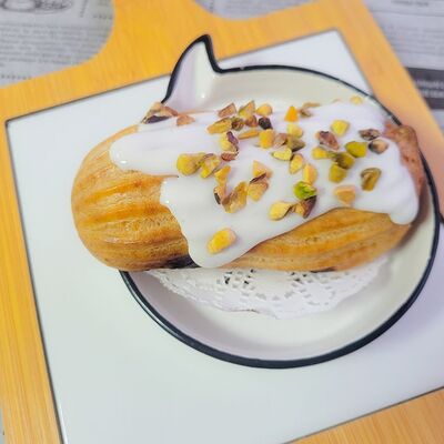 Эклер фисташковый в БлинОК! по цене 109 ₽