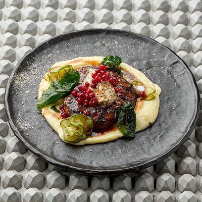 Большая котлета из оленя, жаренная на углях с грибным масломв KITCHEN по цене 1090 ₽