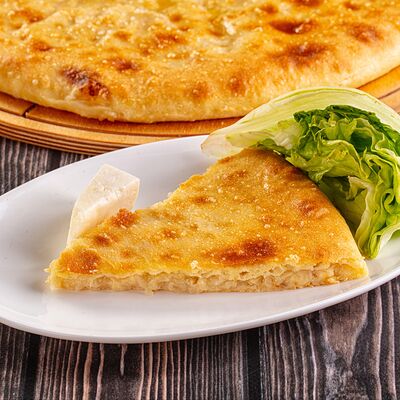 Осетинский пирог с капустой и сыром в Осетинские Пироги по цене 1100 ₽