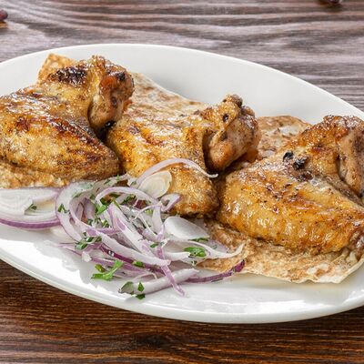 Шашлык из куриных крылышек в Мангал Бар по цене 490 ₽