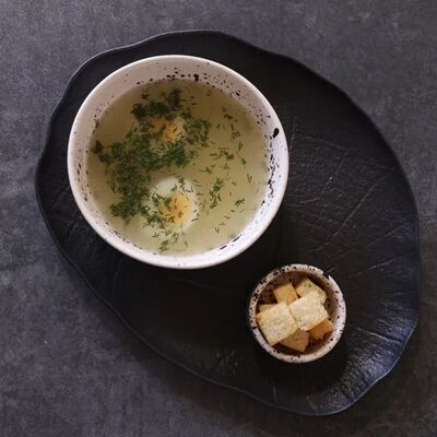 Бульон с яйцом и зеленью в KOKK по цене 350 ₽