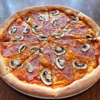 Пицца с ветчиной и грибами в Помидорро по цене 565 ₽