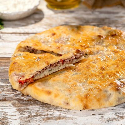 Говядина с помидорами и зеленью 850 г в Пиросетия Осетинские пироги по цене 950 ₽