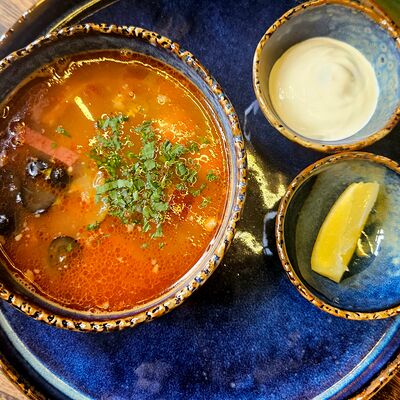 Солянка мясная с маслинами, сметаной и зеленьюв RestoРай по цене 850 ₽