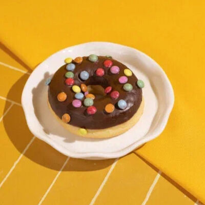 Донат в шоколадной глазури с дражев Пекарня Буханка по цене 179 ₽