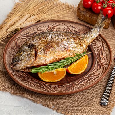 Запеченная дорадо с розмарином и апельсиновыми дольками в Русская кухня по цене 1490 ₽