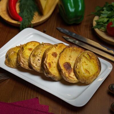 Картофель на мангале в The Кухня по цене 180 ₽