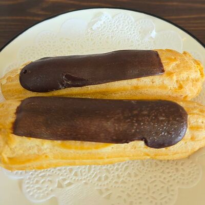 Эклер молочный в Симпл по цене 99 ₽