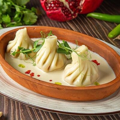 Мини-хинкали с лососем и соусом из белого вина в Ela по цене 899 ₽